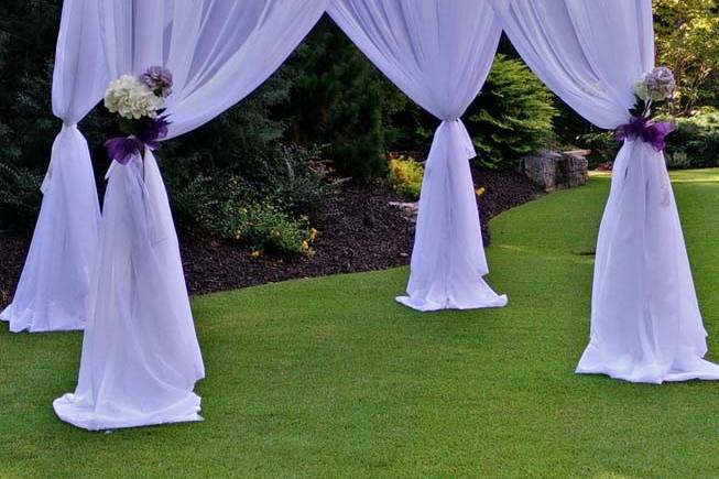 Chuppah with white drapes.