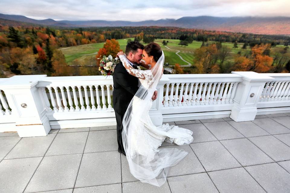 Newlyweds embracing on terrace