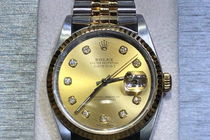 Watch with a golden dial