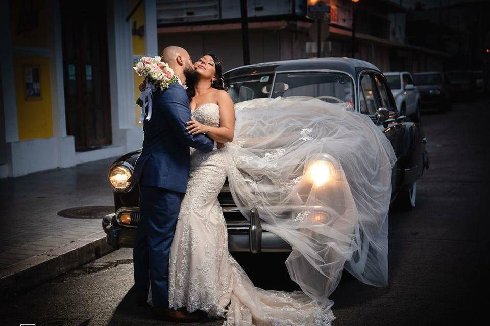 Bride and groom with car