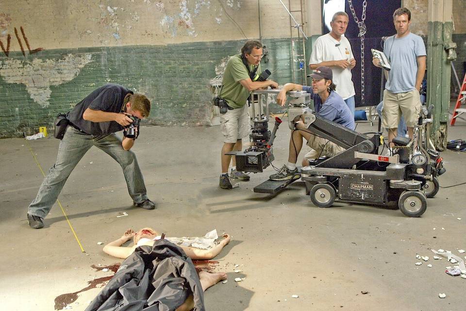 a production still of Richard Scudder shooting still for a prime time TV program