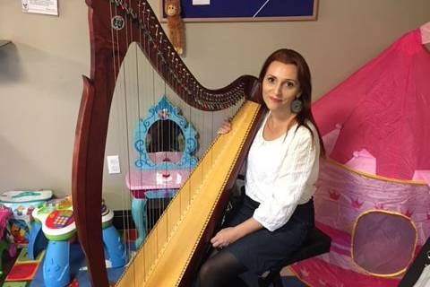 Playing harp for families staying at Ronald McDonald House