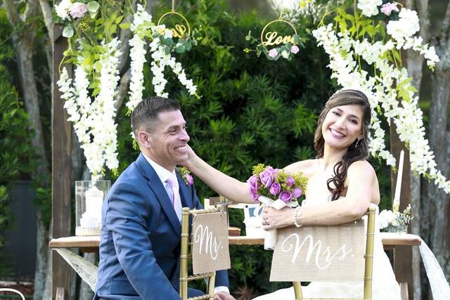Couple by an arch with flowers