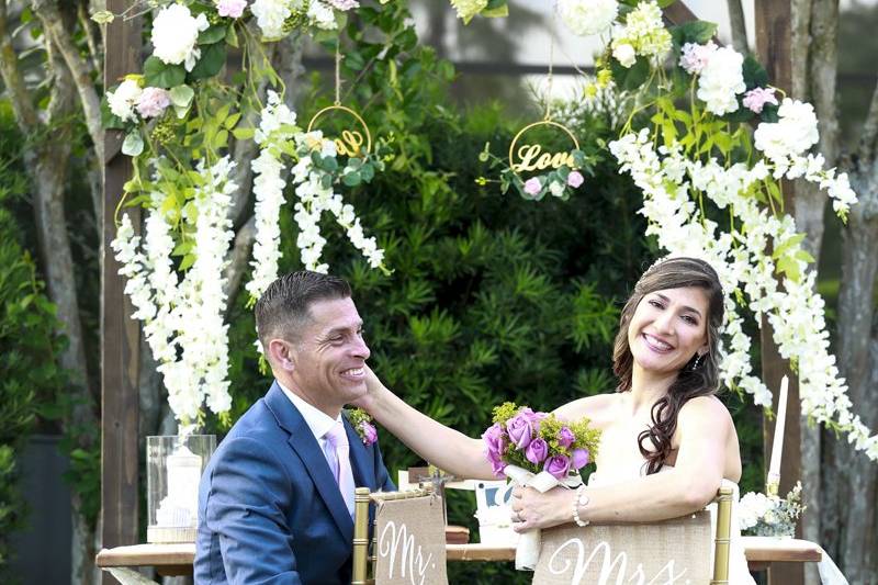 Couple by an arch with flowers