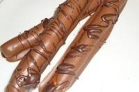 Milk chocolate dipped pretzel rods.