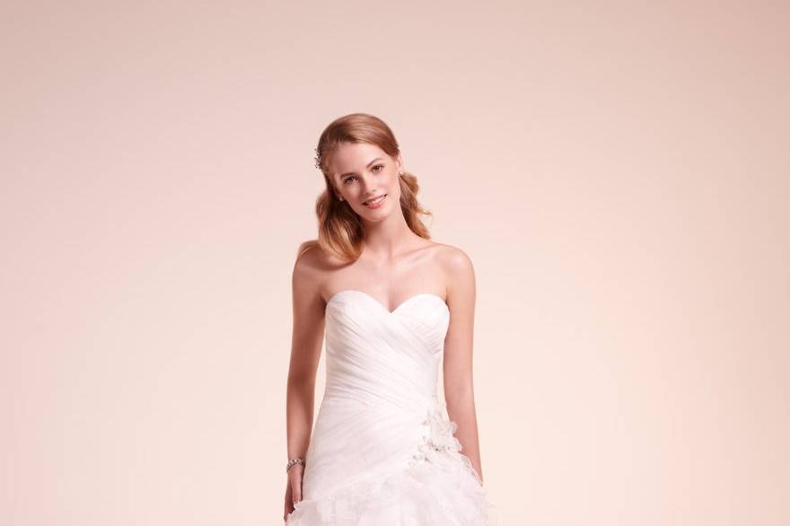 7813
Organza draped gown with ruffled skirt and flral applique at hip