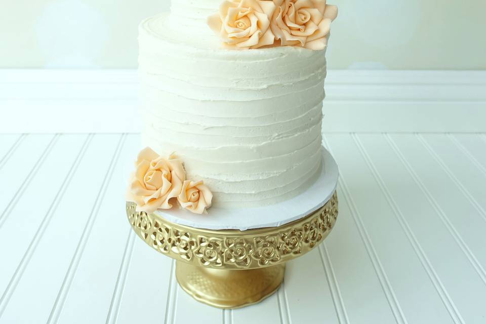 Beautiful buttercream wedding cake with edible sugar roses