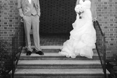 Newlyweds pose by the stairs