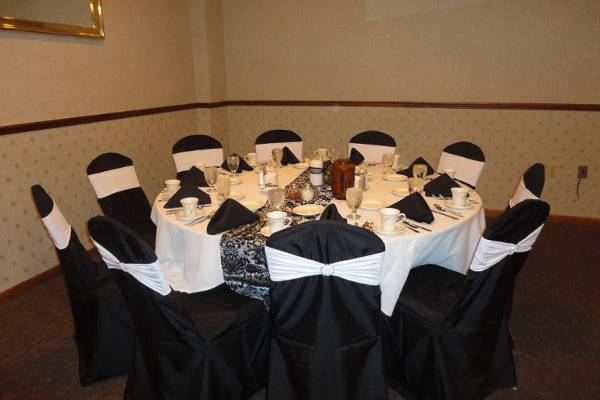 black standard covers with white rhinestone bands, and silver/black damask table runner