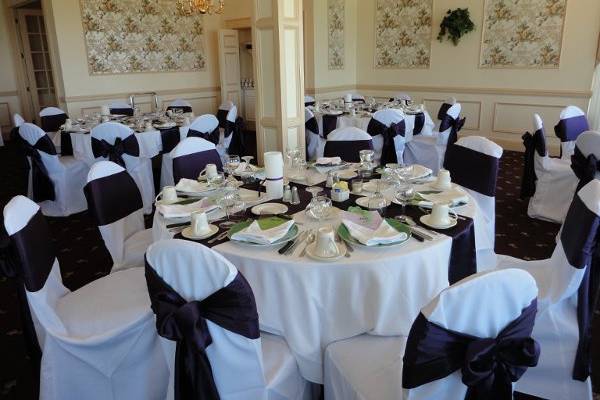 white standard covers w/ plum satin sashes and plum table runners
