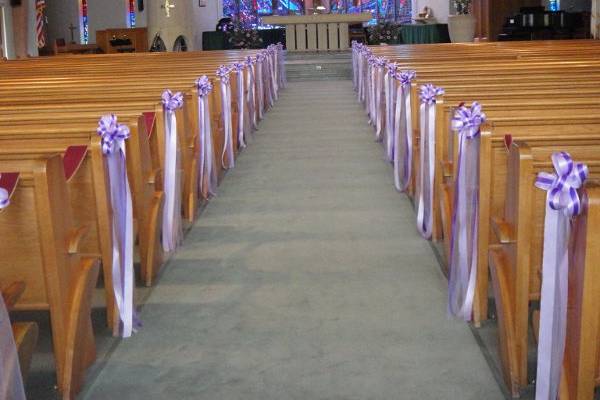 Pew Bows With Purple And Lavander Ribbon.