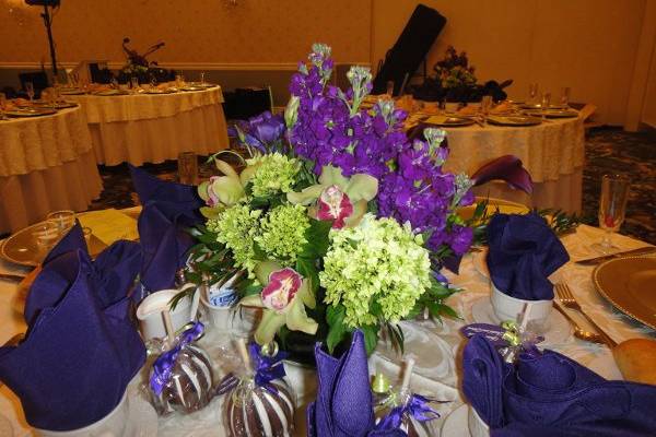 Center Piece With Purple Stock, Green Mini Hidrengea, Green Cymbidium Orchids And Purple Calla Lilies.