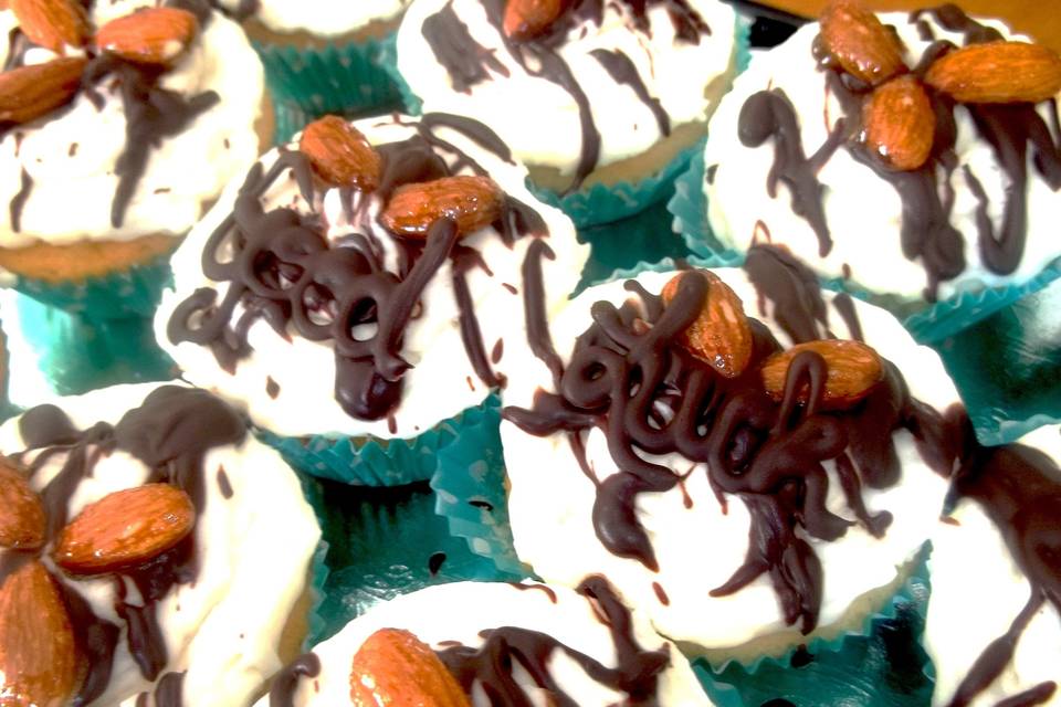 Good Luck Cupcakes - sweet almond white cake with coconut cream frosting, topped with homemade candied almonds, ganache drizzle and a dark chocolate 