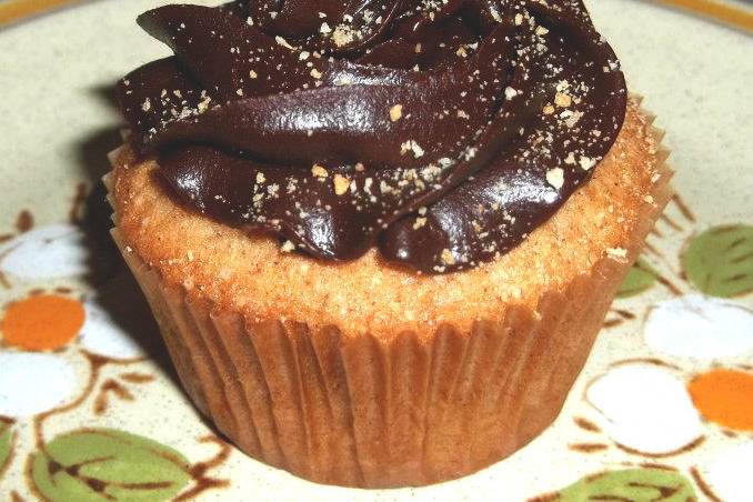 S'mores Cupcakes - Graham cracker cupcake filled with homemade marshmallow and topped with a dark chocolate ganache frosting. Finished with graham cracker crumbs.