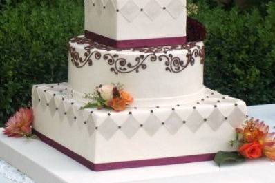 Mixed shape, scrollwork and harlequin pattern fondant-covered cake