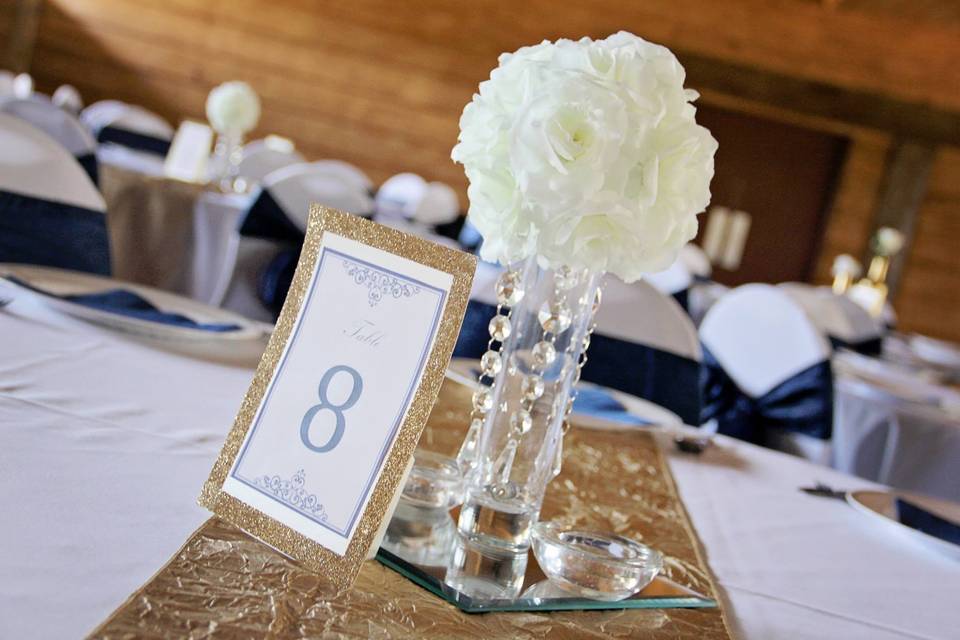 Floral centerpieces and framed table numbers