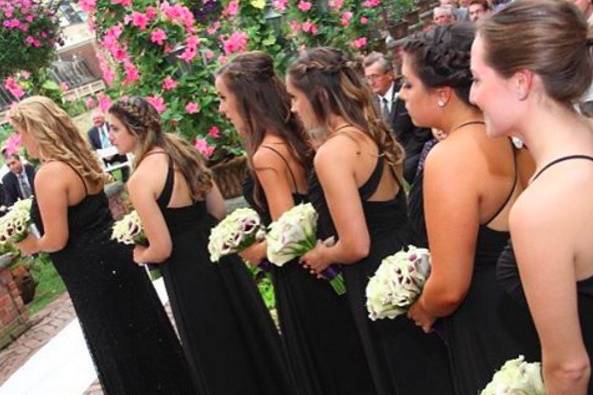 Black for your bridesmaids is perfect for any time of the year. Bridesmaids styled in our Studio in a strappy back dress by Hayley Paige Occasions.