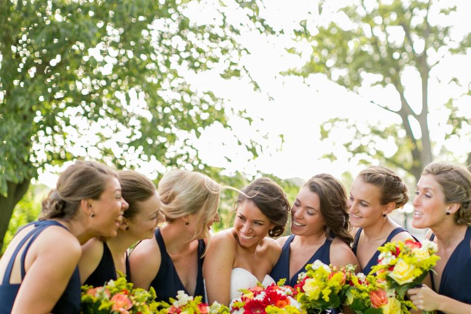 Bari Jay bridesmaids wearing an open back style in navy.