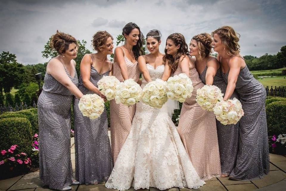 Adrianna Papell bridesmaids wearing the classic blouson dress in blush and dark silver.