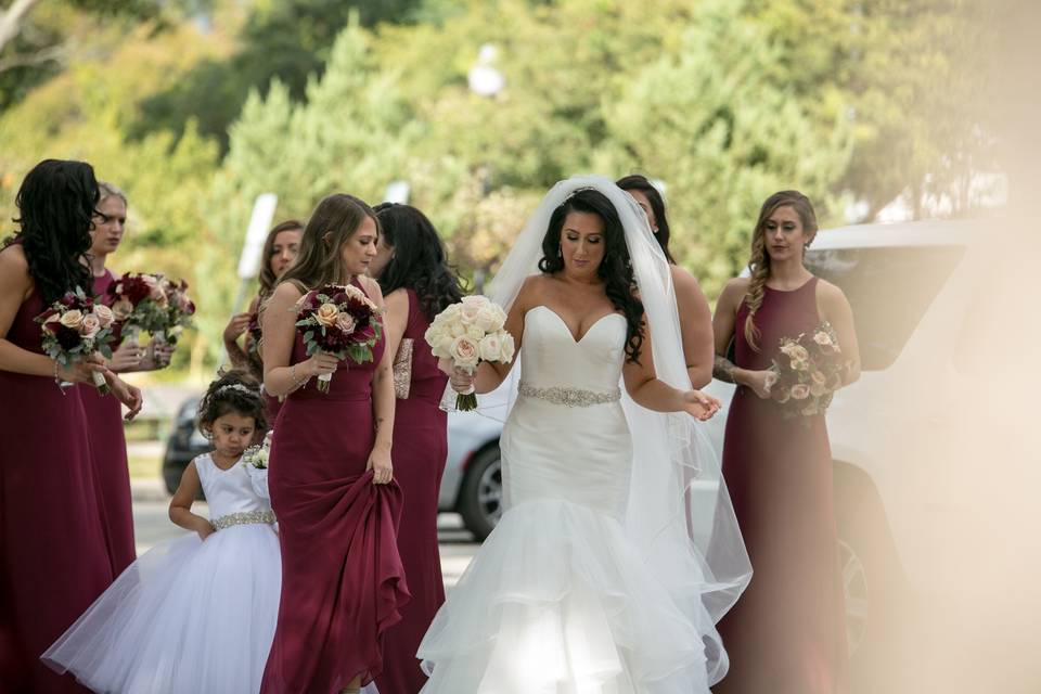Hayley Paige burgundy chiffon bridesmaid gowns with back sheer overlay and center slit. Styled in our Studio.