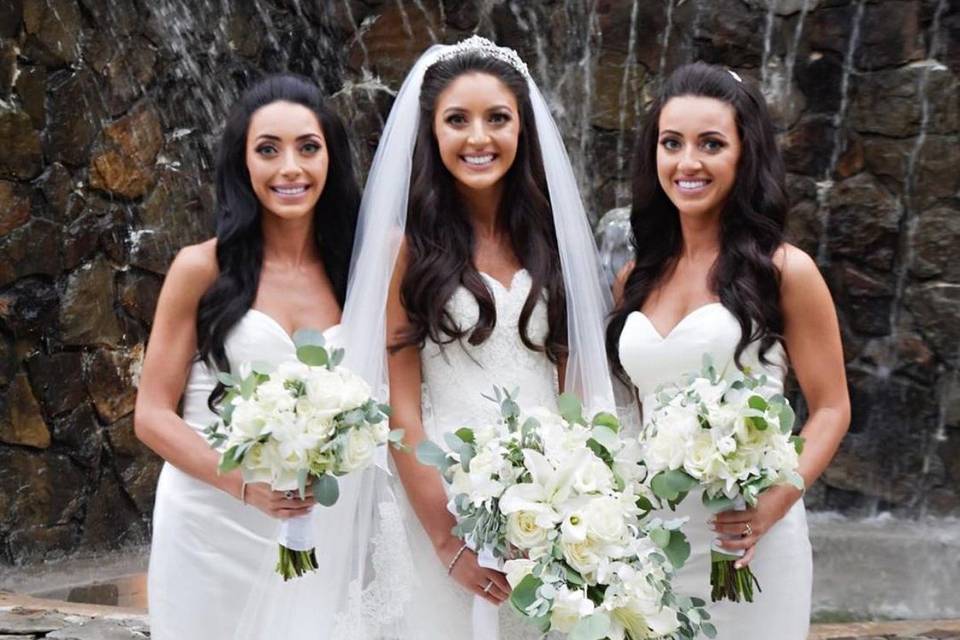 Bridesmaids styled in Hayley Paige Occasions strapless satin dresses in ivory.