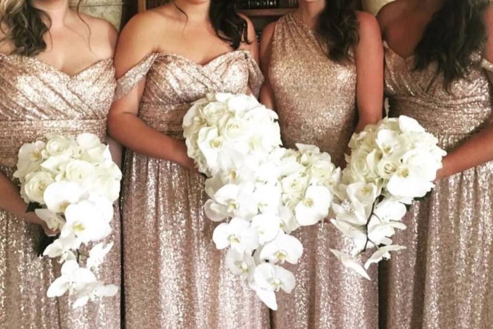 The perfect amount of sequin on these bridesmaids! Wearing Amsale in gold.
