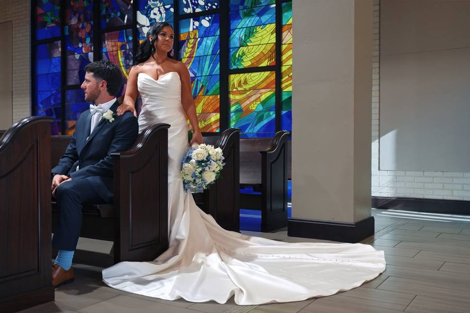 Cinematic film still of Kolbi & Ryan during the first touch on their wedding day at St. John the Evangelist in Prairieville, Louisiana captured by Enchanted Cinema Co. Baton Rouge wedding videographers.jpg