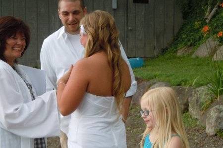 Officiant with the newlyweds and family