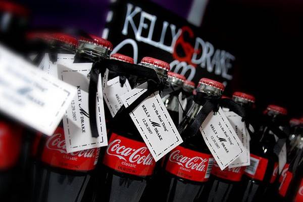 Guests at Kelly & Drake's wedding took home glass coca cola bottles with tags