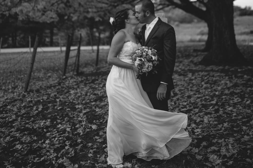 Couple posing beneath a tree