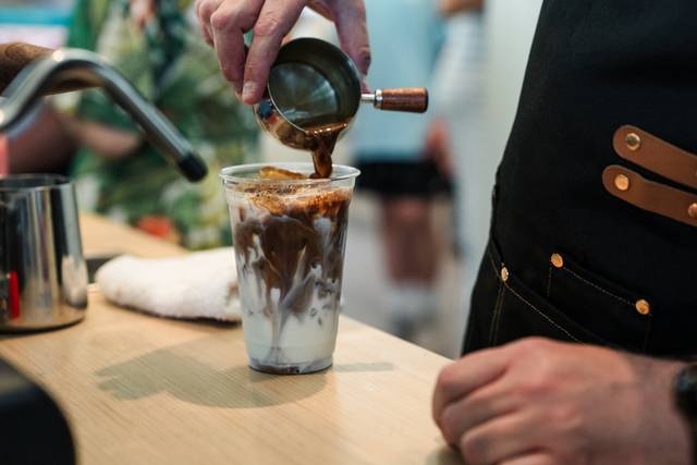 Barista pouring espresso drink