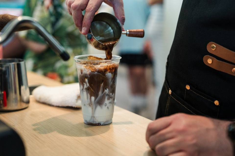 Barista pouring espresso drink