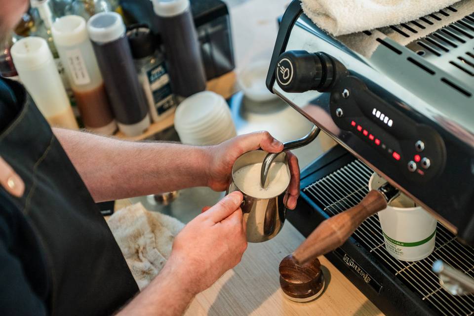 Barista steaming milk