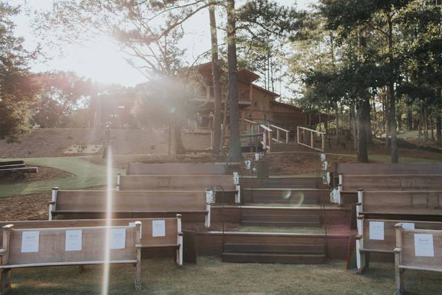 View of ceremony seating area up to reception barn