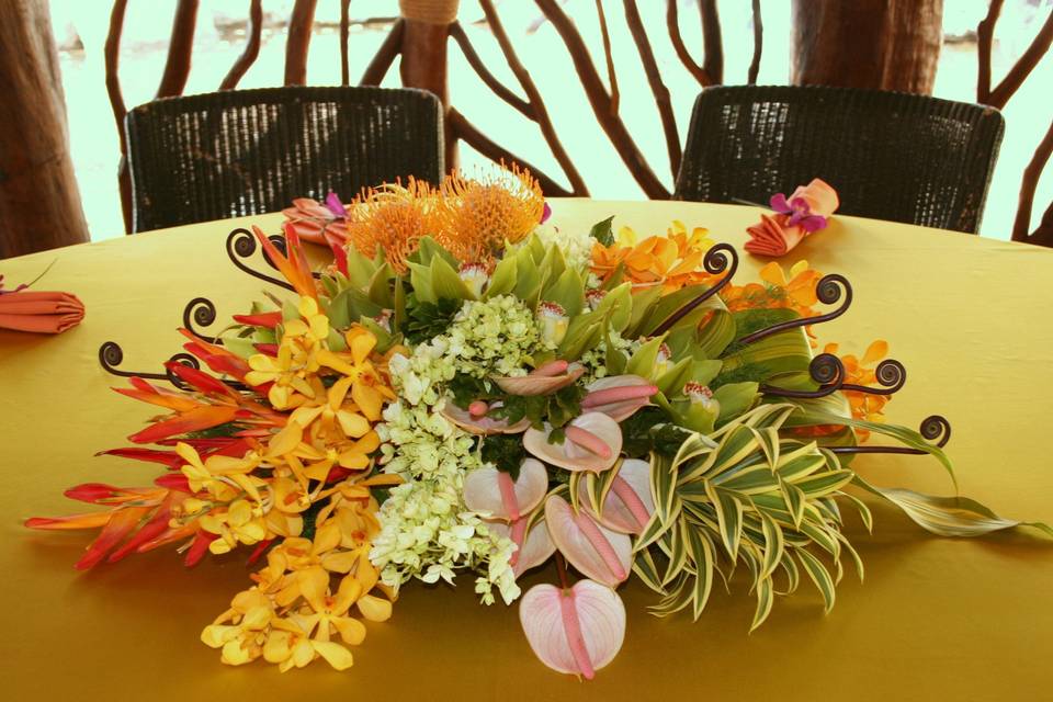 Lush pockets of Tropical flowers create an elegant centerpiece