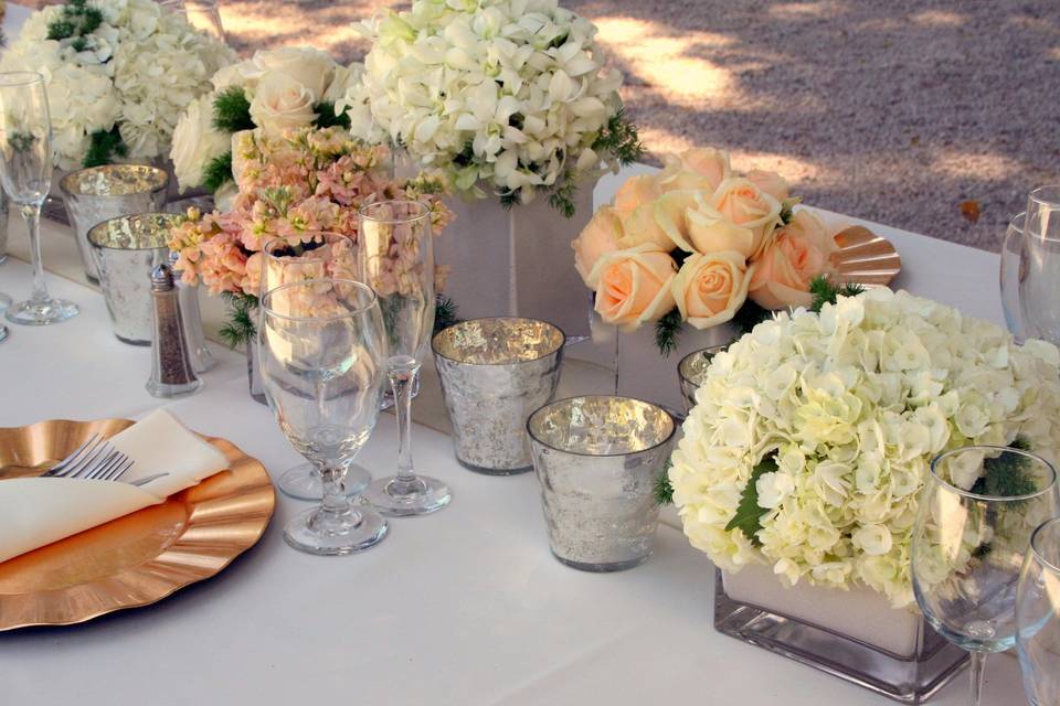 Antique peach and ivory tones accented by mercury glass votives