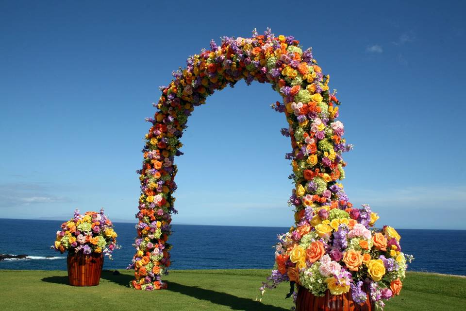 Floral arch accented by axillary arrangements