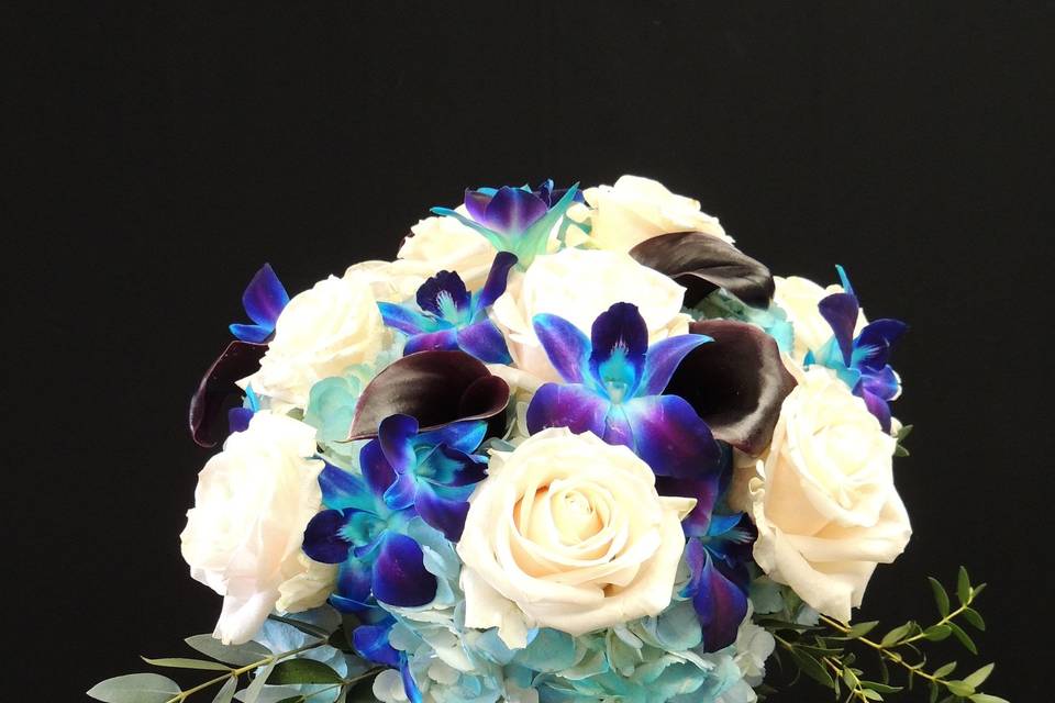 Bridal bouquet with blue hydrangea, blue orchids, vendela roses, purple mini callas