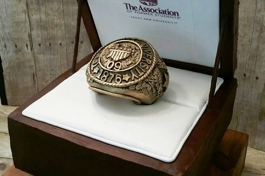 Aggie ring hand-sculpted with LOVE! Carved out of modeling chocolate.  Cake is a rich chocolate torted with chocolate butter cream covered in chocolate ganache.  Jordan was thrilled with 