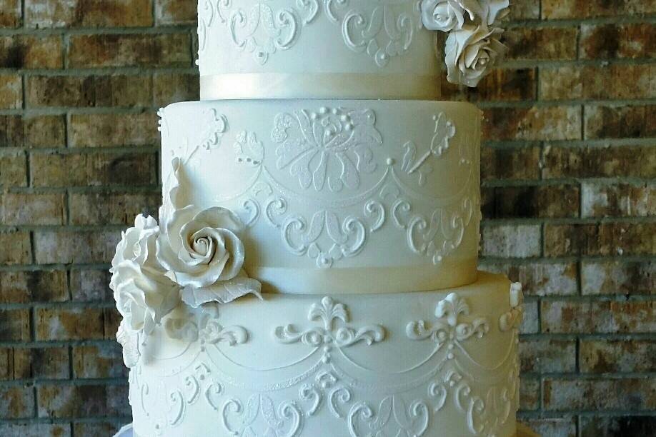 Butter cream 1st and 2nd tier.  Bottom tier is fondant covered with personalized hand-painted flowers.  Beautiful.