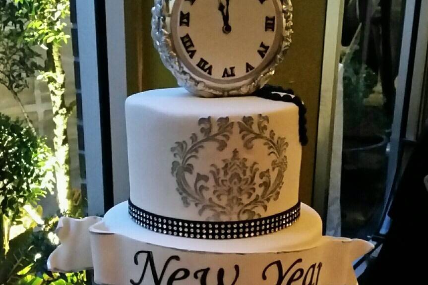 Romantic square wedding cake.  Top 3 tiers are fondant with lace applique decor.  Bottom tier is blush butter cream rosettes.