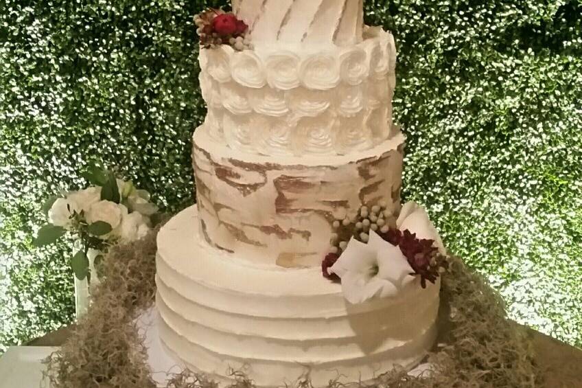 5-tier butter cream wedding cake.  Brittany wanted every tier to be different and it was fun to design.  We hand-painted edible gold & bronze paint on our 