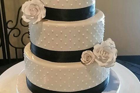 Black & White Swiss Dot Wedding Cake.  Gum paste flowers tipped in gold.