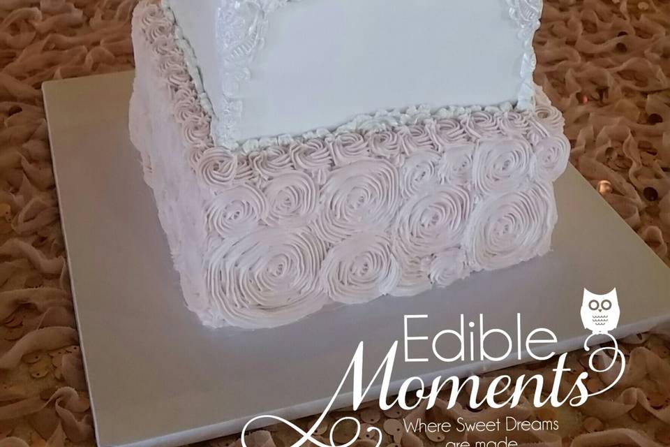 Romantic square wedding cake.  Top 3 tiers are fondant with lace applique decor.  Bottom tier is blush butter cream rosettes.