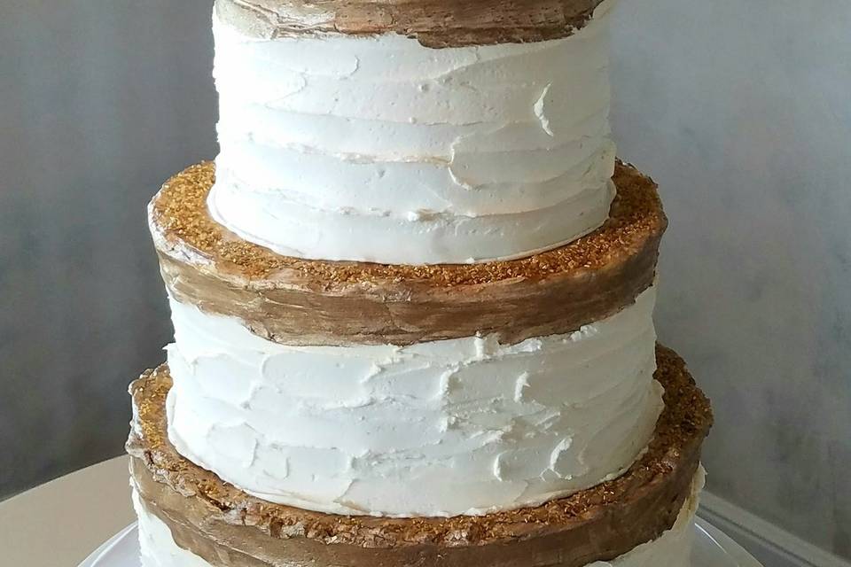 Butter Cream wedding cake featuring a double barrel tier with fondant lace decor