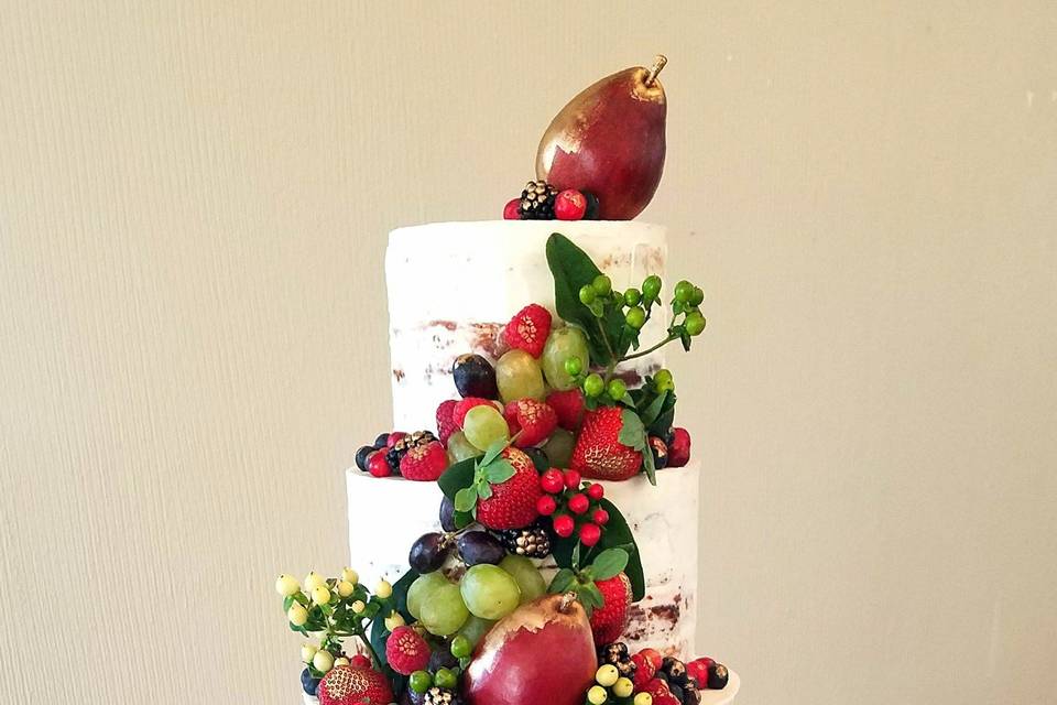 Naked Cake design with fresh fruit accented with hand-painted edible gold paint.  Bottom tier is butter cream air-brushed in gold.  Love those Red Pears!