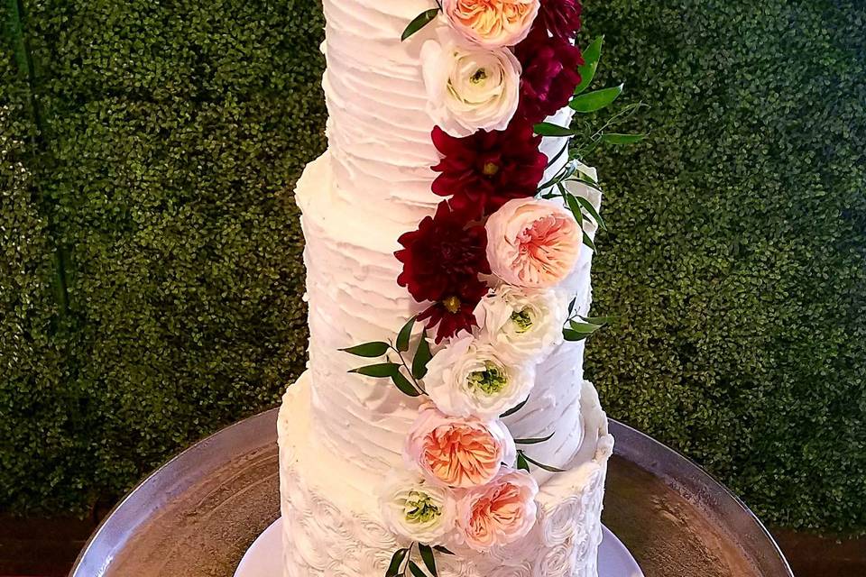 Featuring Double Barrel tiers, this Butter Cream Beauty Wedding Cake stands just over 4-feet tall! Gorgeous Fresh Florals!