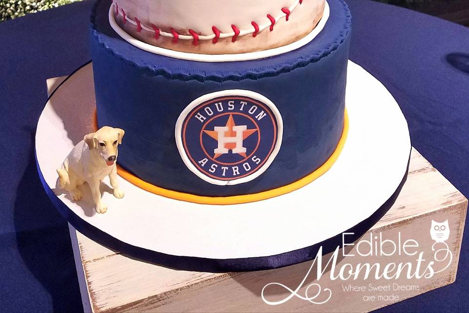 Aggie Class Ring Groom's cake.  Aggie Ring made out of crispy treats and white chocolate.  All hand-carved and hand-painted custom to match groom's ring with diamond center.  Wood tier cake carved with bridal's monogram is our chocolate decadence.