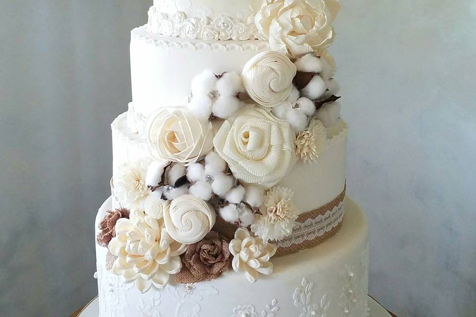 Cotton themed wedding cake with stenciling & bridal monogram.  Florals hand-made from wood.