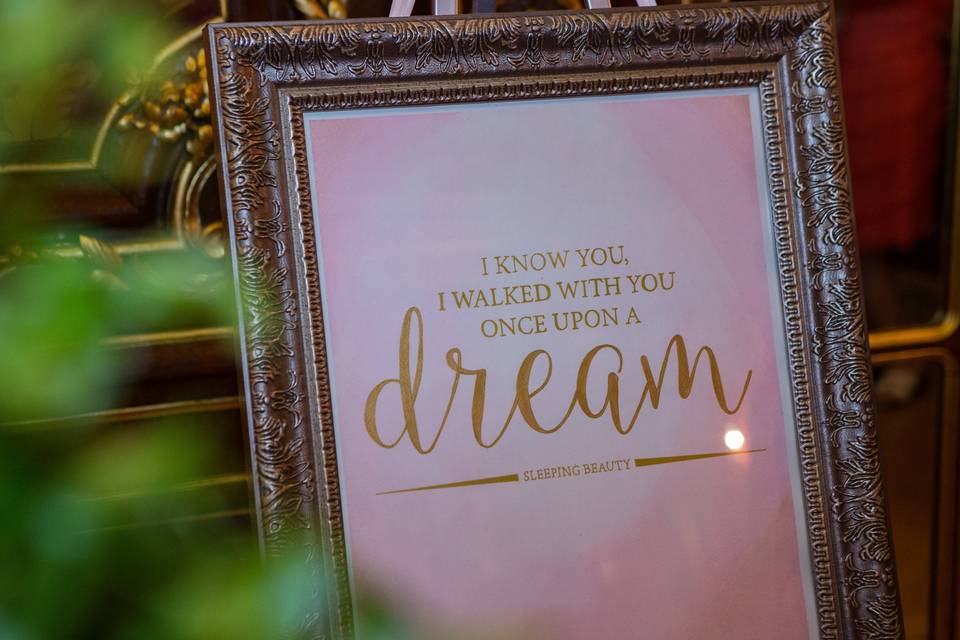 A fairy tale wedding complete with quote signs from the romance of Disney movies, including this one highlighting Sleeping Beauty. Handpainted watercolor and gold lettering.